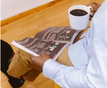 A person is drinking coffee while reviewing license requirements for Connecticut